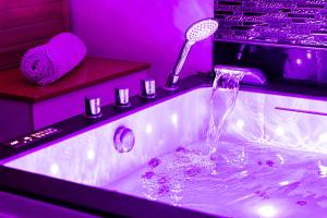a bathroom with a sink with a faucet at "glamappartspa" design experience & Parking in Dijon +15 photos