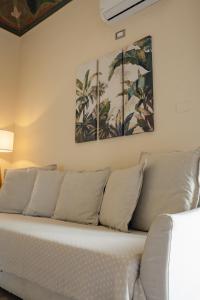 a couch in a room with two paintings on the wall at B&B Matteo Bonello - Fianco Cattedrale in Palermo