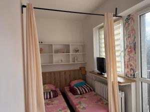 a small room with a bed and a window at Radiant BD Wejscie na kod in Gdynia