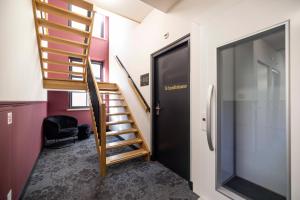 a spiral staircase in a room with a door at Bakery Boutique Hotel in Leeuwarden