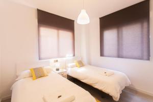 A bed or beds in a room at Granada Home Centro