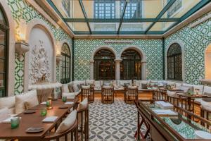 a restaurant with tables and chairs in a room at Palacete Severo in Porto
