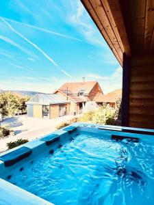a large swimming pool on top of a house at La lisière romantique in Granges-Aumontzey