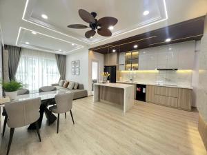 a kitchen and living room with a ceiling fan at TA Nhatrang Apartment in Nha Trang