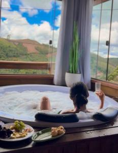 a young child in a jacuzzi in a room at Chales Vidal in Venda Nova do Imigrante