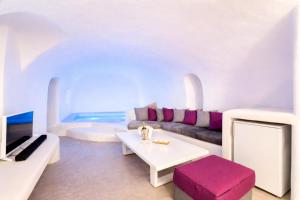 a white living room with a couch and a table at Kampanario Luxury Two-Bedroom Villa with Private Jacuzzi in Megalochori