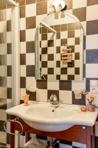 a bathroom with a sink and a mirror at Bed & Boterham Carpediem in Hamont
