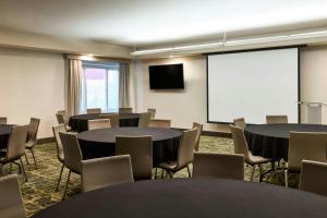 a conference room with tables and chairs and a screen at SpringHill Suites Prescott in Prescott +32 photos