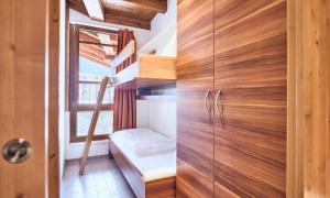 a small room with wooden cabinets and a window at Grafenberg Resort by Alpeffect Hotels in Wagrain +58 photos