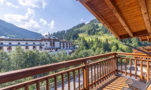 a balcony with a view of a town at Grafenberg Resort by Alpeffect Hotels in Wagrain