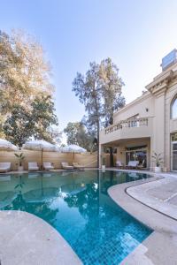 a swimming pool in front of a building at Sam's Story Boutique Hotel in Cairo