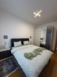 a bedroom with a large bed with pillows on it at Kalisi Panorama Tornik in Zlatibor +10 photos