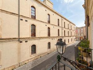 a view of a street from a balcony of a building at Ortigia Mastrarua rooms in Syracuse
