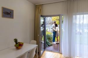 two people standing on the patio outside of a house at Nyíltvízi Edzőközpont in Dunakeszi +7 photos