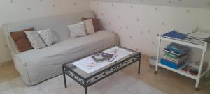 a small room with a couch and a table at le moulin à vent in Céré-la-Ronde +10 photos