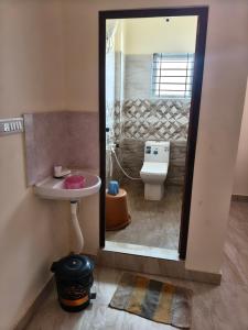 a bathroom with a sink and a toilet at Kalpatharu Sprit Boarding and Lodging in Sivaganga