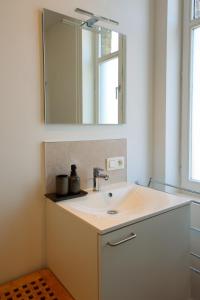 a bathroom with a sink and a mirror at Suite kaai 24 in Nieuwpoort +22 photos