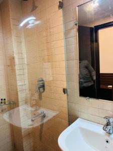 a bathroom with a sink and a mirror at AairHotel in Karnal