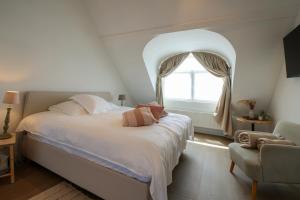 a bedroom with a large bed and a window at Suite kaai 24 in Nieuwpoort