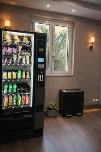a vending machine with drinks in a room at Est Hotel in Paris