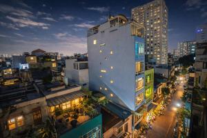 a tall white building in a city at night at 1001 Stars Hotel in Ho Chi Minh City
