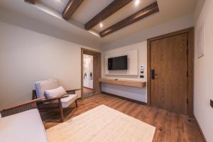 a living room with a couch and a television at Sam's Story Boutique Hotel in Cairo