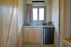 a kitchen with a sink and a window at Rooster Guesthouse Rooms in Kipri +36 photos