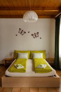 a bedroom with a bed with butterflies on the wall at Ca' di Pincia in Astano
