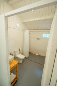 a bathroom with a toilet and a sink at The Pearl Beach Resort in Canacona +33 photos