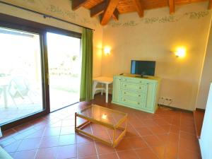 A television and/or entertainment centre at Holiday home in Sardinia with pool and terrace with country views