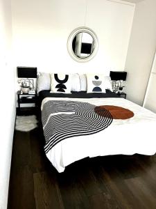 a bedroom with a large bed and a mirror at Executive Suite-Business Edition in Zurich