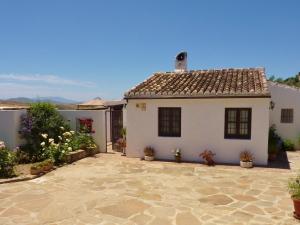 a white house with a tile roof at Belvilla by OYO Casa Coqui Juan Ram n in La Joya