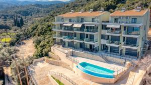 an aerial view of a house with a swimming pool at Emmari Luxury Suites in Episkopos