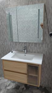 a bathroom with a sink and a mirror at kooshal Seetul Flacq Flat in Centre de Flacq