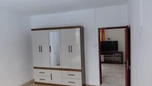 a room with a mirror and a dresser and a television at kooshal Seetul Flacq Flat in Centre de Flacq +2 photos