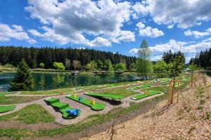 a park with a bunch of playground equipment next to a lake at Apartment Lale - Frankenwald, Waldblick & Rennsteig in Steinbach am Wald