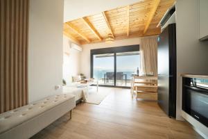 a living room with a couch and a tv at Emmari Luxury Suites in Episkopos