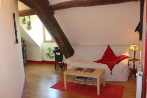 a living room with a white couch and a table at Chambres d'hôtes de Champendu in Azy-le-Vif