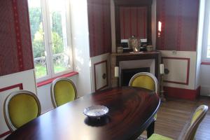 a dining room with a wooden table and chairs at Chambres d'hôtes de Champendu in Azy-le-Vif