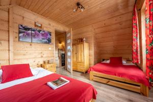 a bedroom with two beds in a log cabin at Chochołowskie Domki in Chochołów