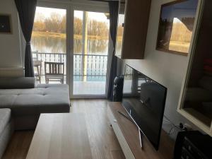 a living room with a couch and a flat screen tv at Biser jezera in Gornja Šuma