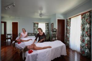 a group of women laying on beds in a room at Hawaii Island Retreat at Ahu Pohaku Ho`omaluhia in Kapaau