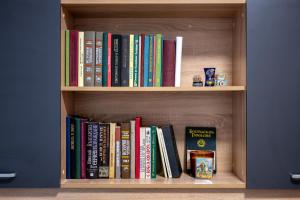 a book shelf with many books on it at Martin's Treasure TOP CENTER in Sofia +10 photos