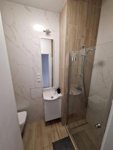 a bathroom with a shower and a toilet and a sink at Tatamka Hostel in Warsaw +65 photos