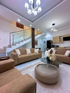 a living room with two couches and a table at Chevy Chase Gardens, 9 in East Legon