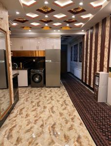 a kitchen with a refrigerator and a stove at Madina plaza 2 in Kabul