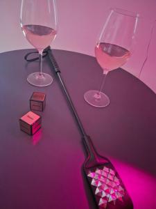 a bottle of wine and a glass of wine at love room les plaisirs partagés in Arles