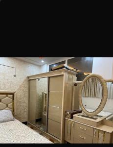 a bedroom with a mirror and a dresser at Madina plaza 2 in Kabul