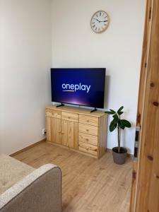 a flat screen tv sitting on top of a wooden dresser at Apartmán Bellevie in Znojmo