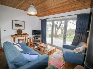 a living room with two blue couches and a table at Bosca Neadu in Dingle